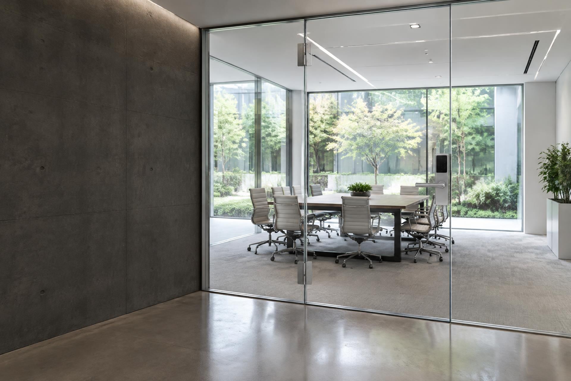 Bright office with switchable smart glass and a smart lock on a frameless glass door